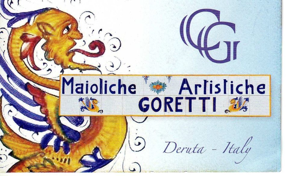 Insegna in piastrelle di maiolica con la scritta Maioliche Artistiche Goretti, Deruta, e un drago dipinto
